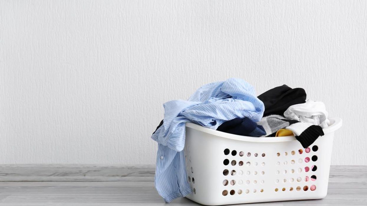 White laundry basket with clothes overflowing