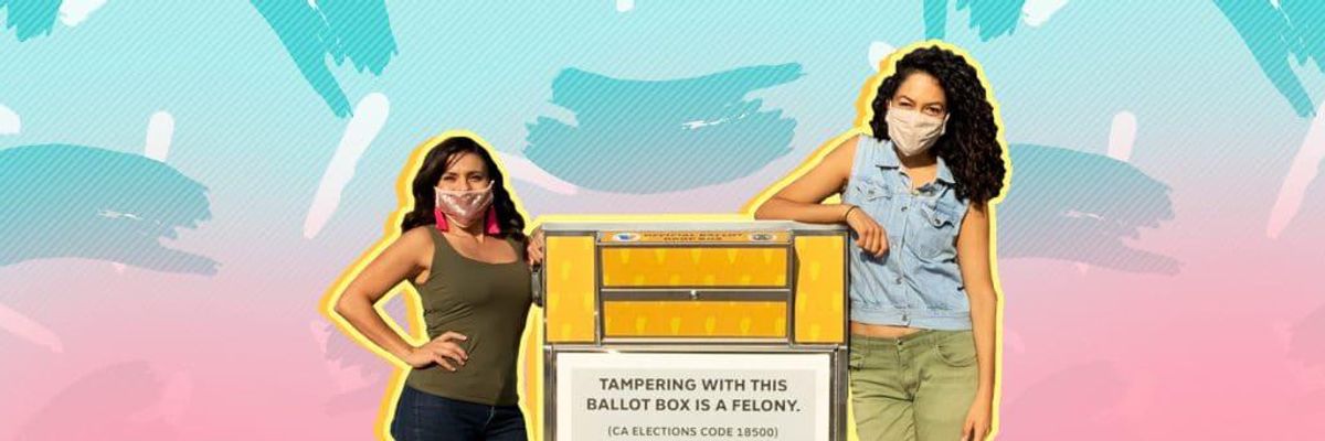 two women standing next to a ballot box