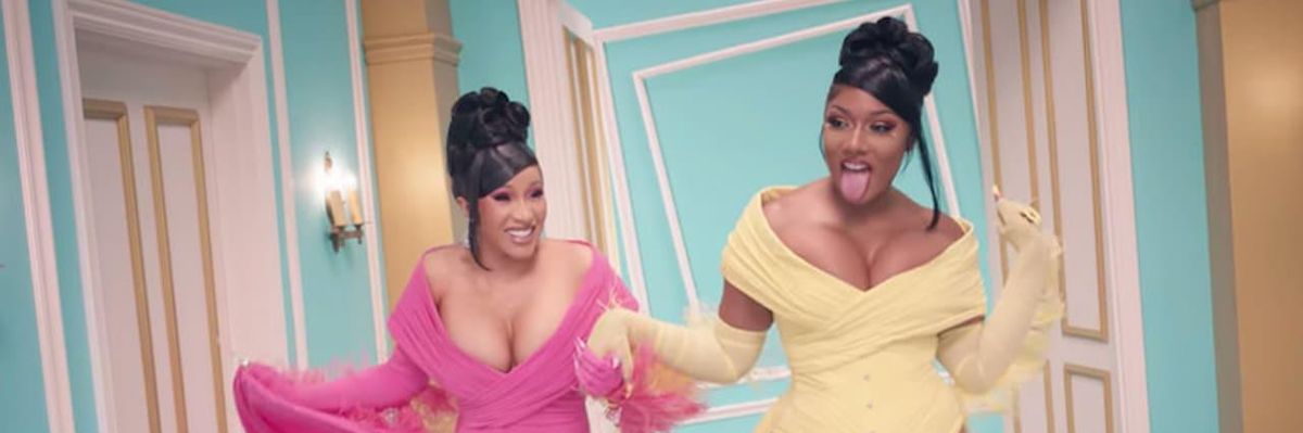 Cardi B with a pink dress and Meghan Thee Stallion on a yellow dress