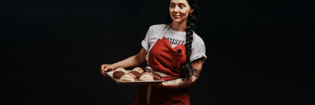 woman, Mariela Camacho, holding pastries