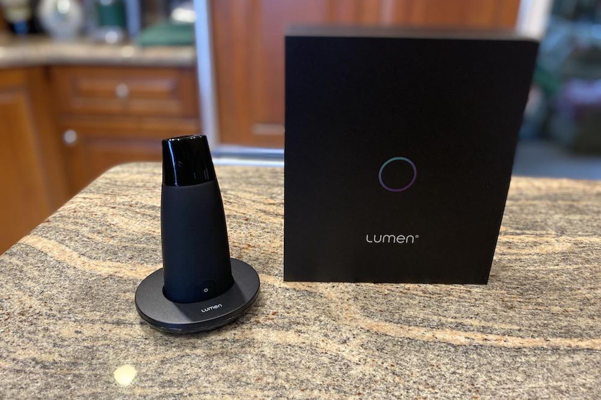 Lumen on charging stand and box on a countertop