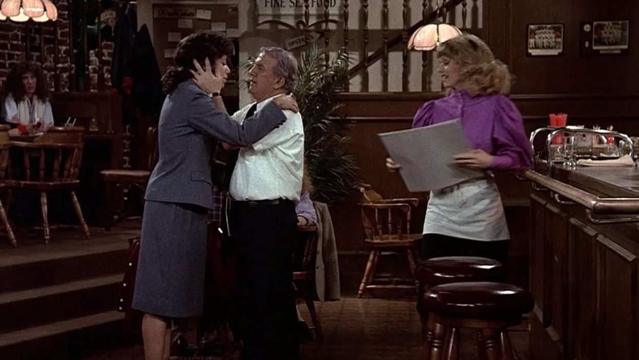 Coach embracing daughter Lisa while Diane looks on holding a sketch pad