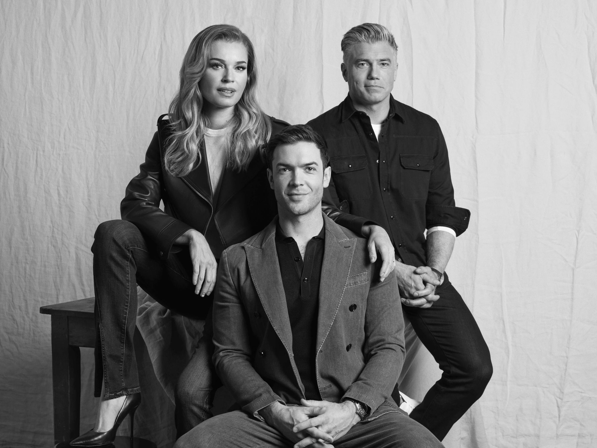 The three leads of Star Trek Strange New Worlds pose against a canvas backdrop.