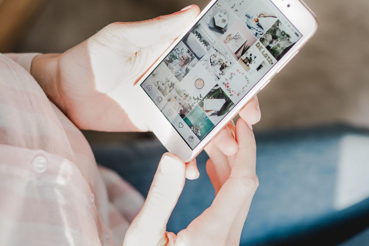 Person scrolling through Instagram ads