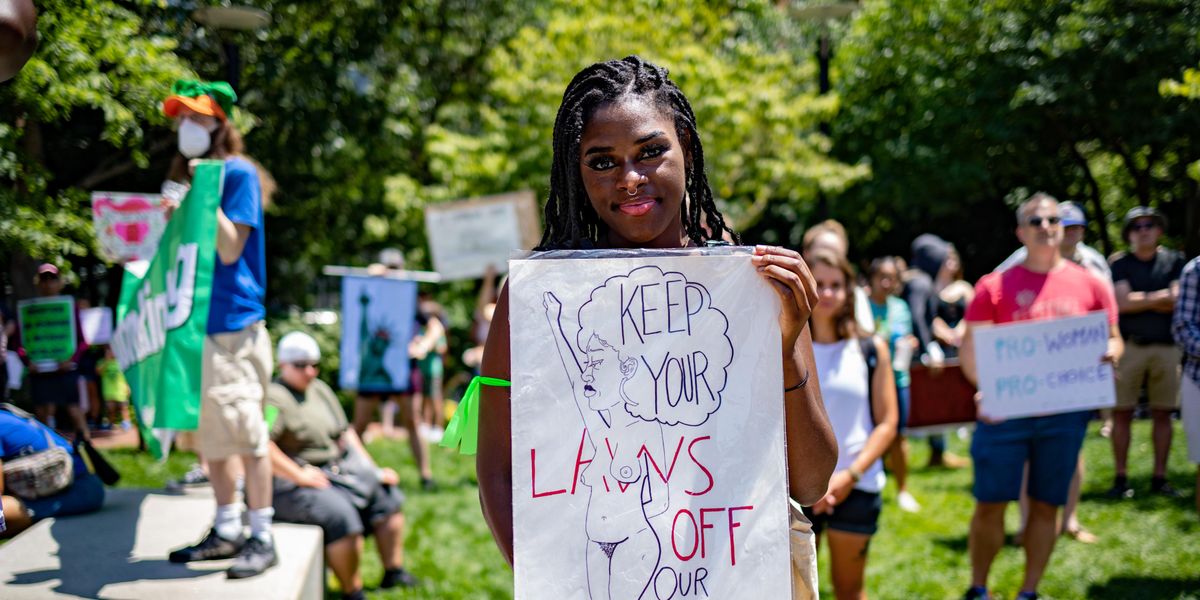 a-black-woman-protester-holding-up-a-sign-during-abortion-protest