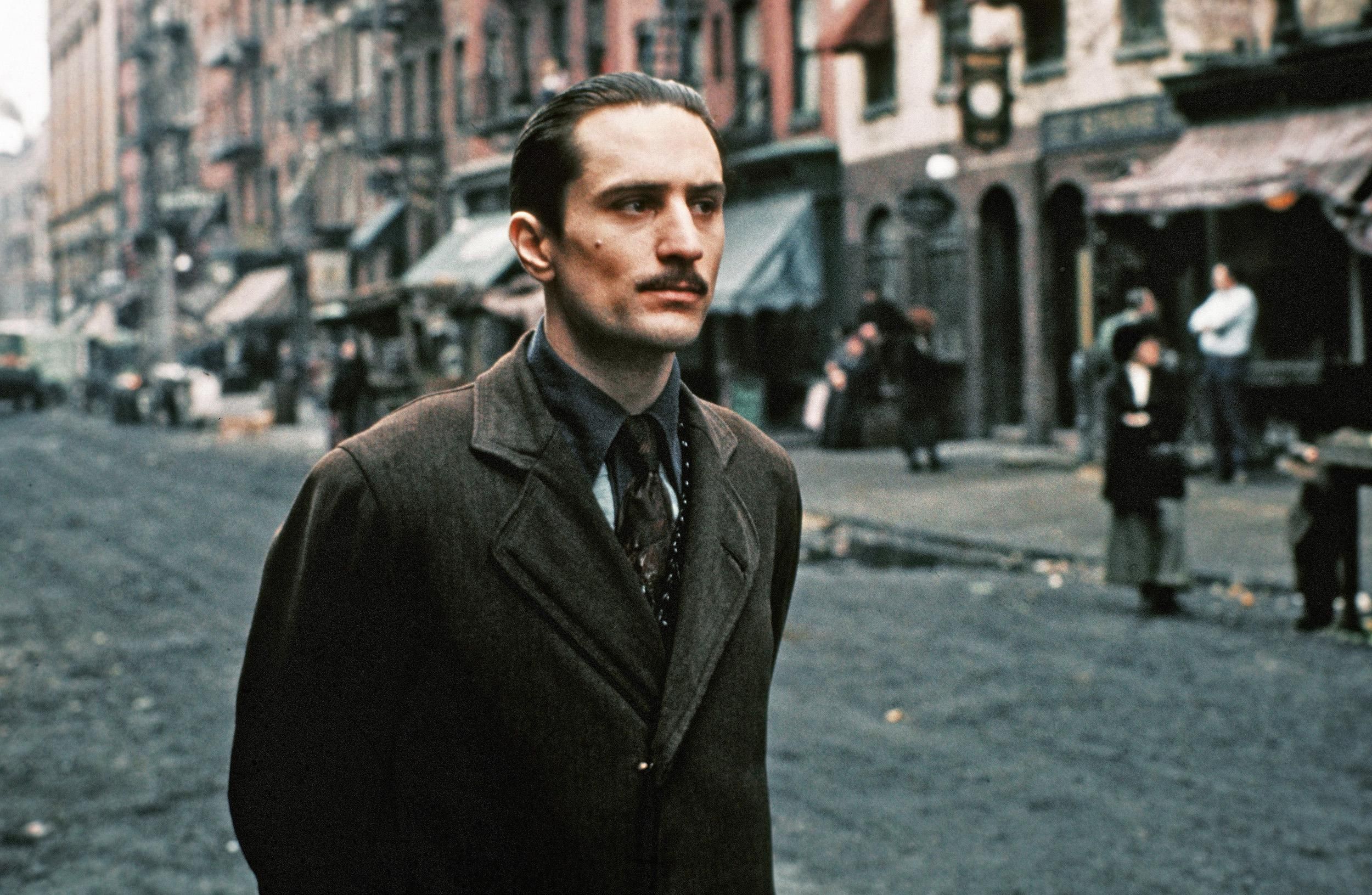 Robert De Niro as young Vito Corleone stands on a street in Little Italy in a scene from the Godfather Part II