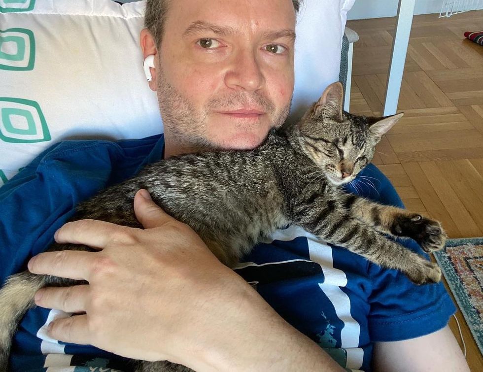 blind kitten cuddling foster dad