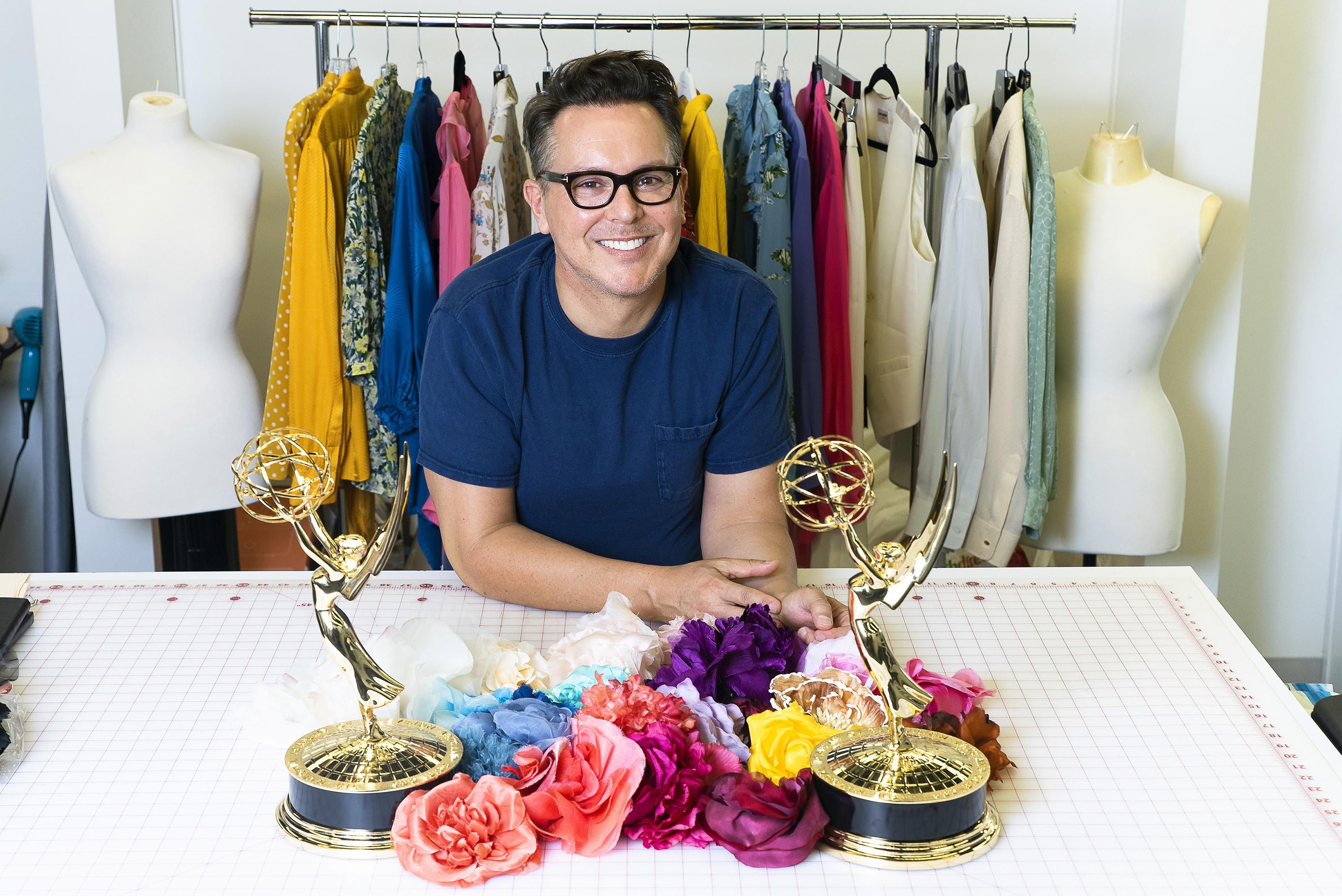 The award winning costume designer for Drew Barrymore Show sits in a styling room with several Emmy statuettes.