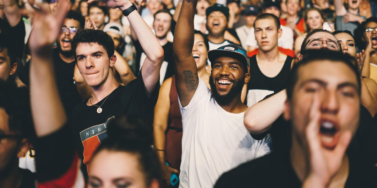 crowd of young people standing and cheering