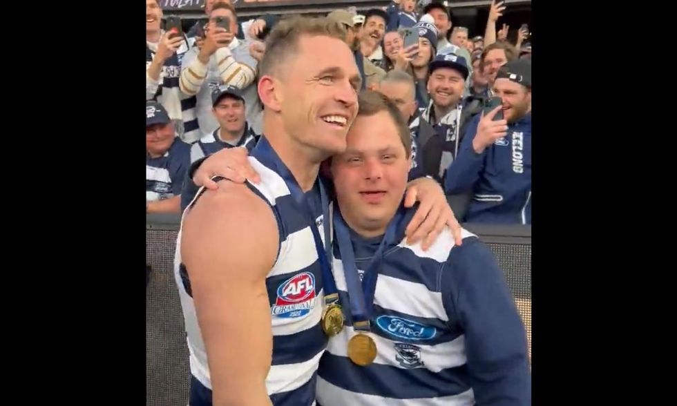 'We share a very special friendship': Aussie football captain and water boy with special needs celebrate together after title win