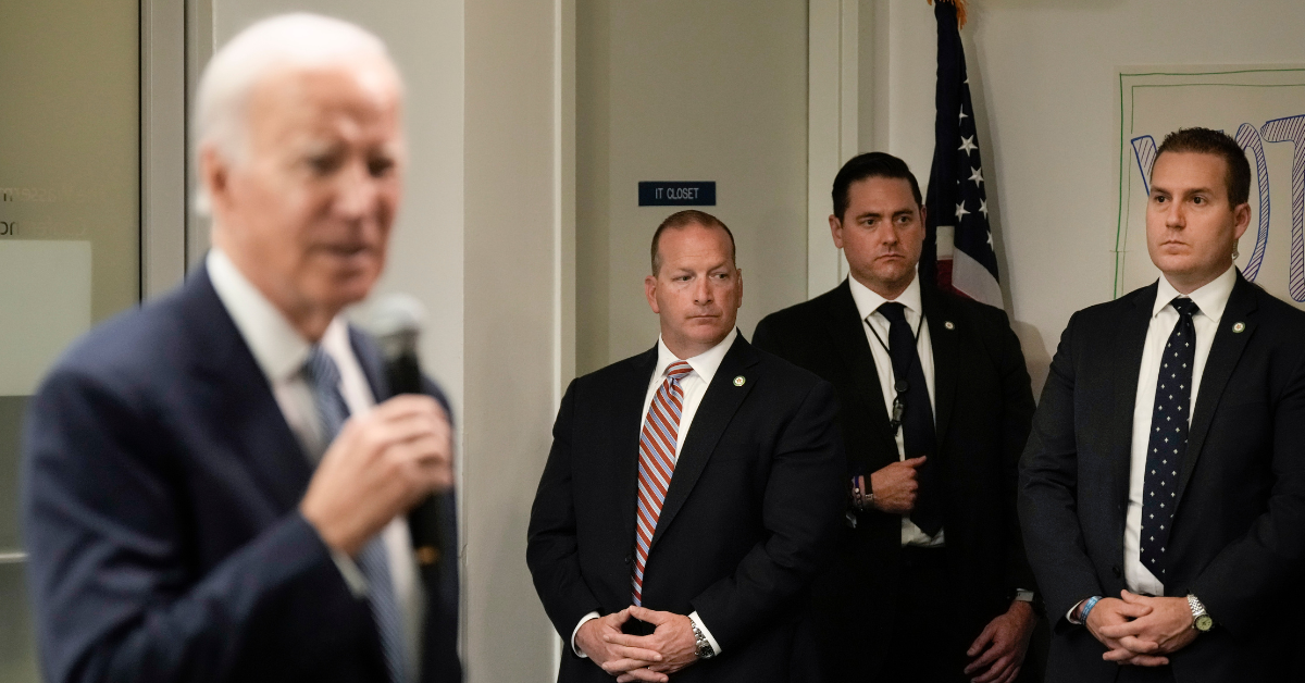 President Joe Biden in foreground with Secret Service agents in background