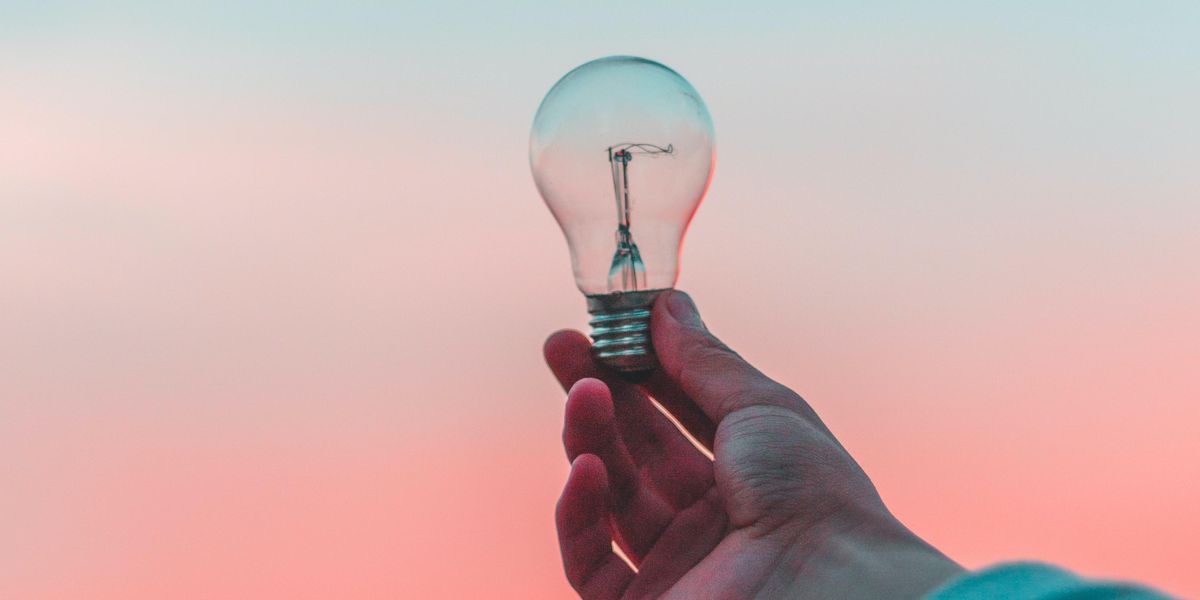 Hand holding a lightbulb