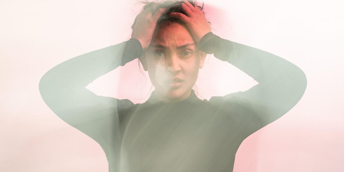 Woman holding her head looking frustrated
