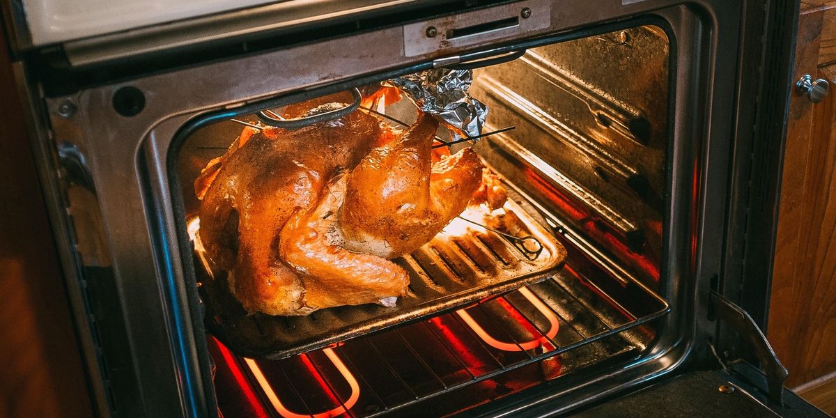 roast turkey in an oven on a broiler pan
