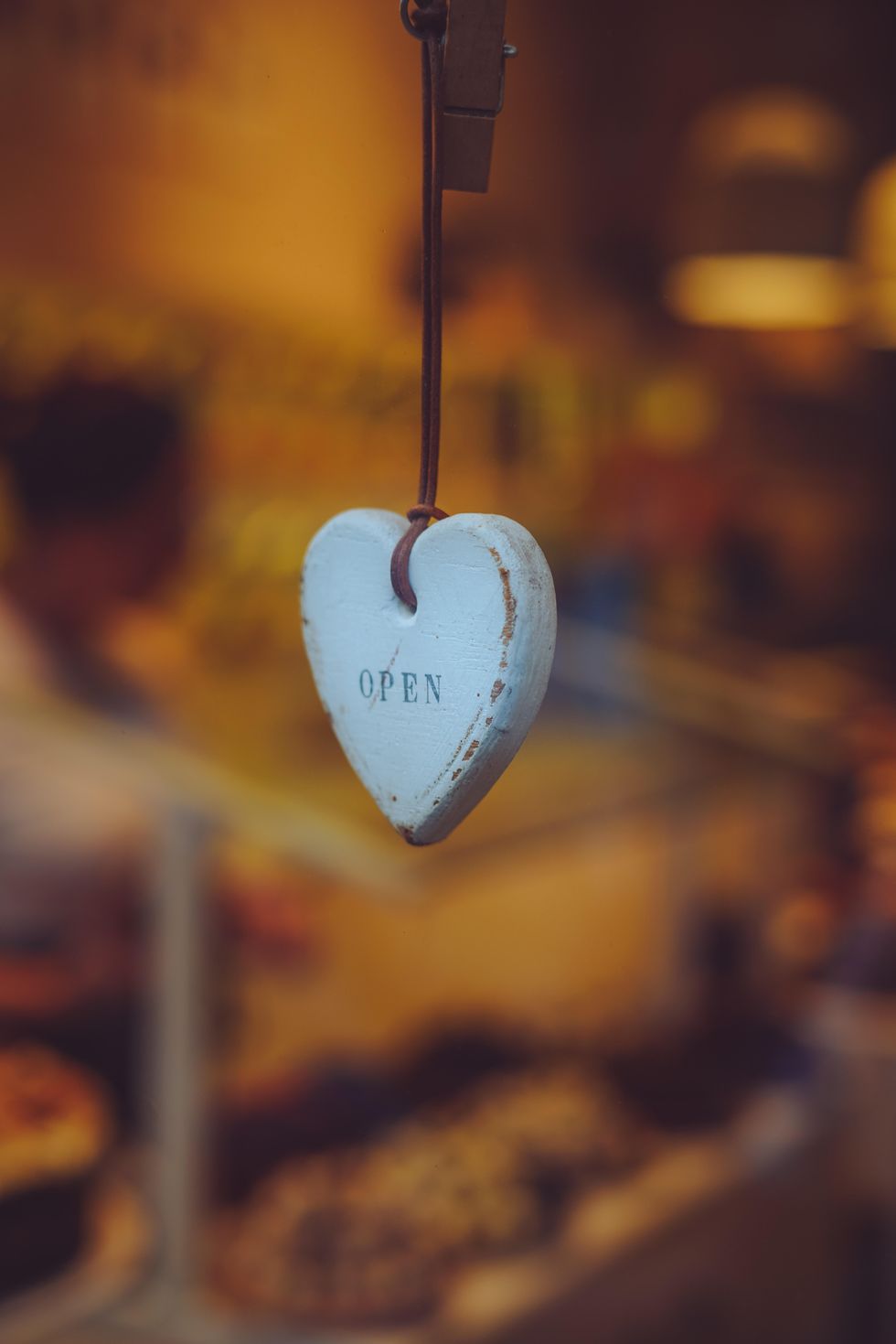 A wooden heart decoration with the words 'open'.