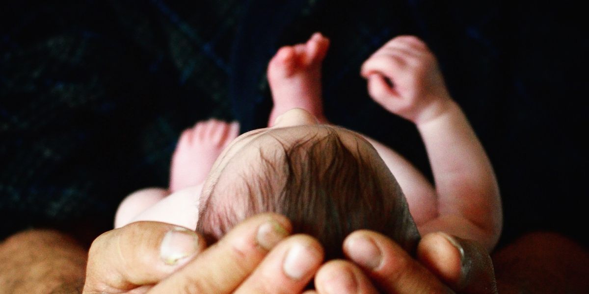 Person holding newborn baby