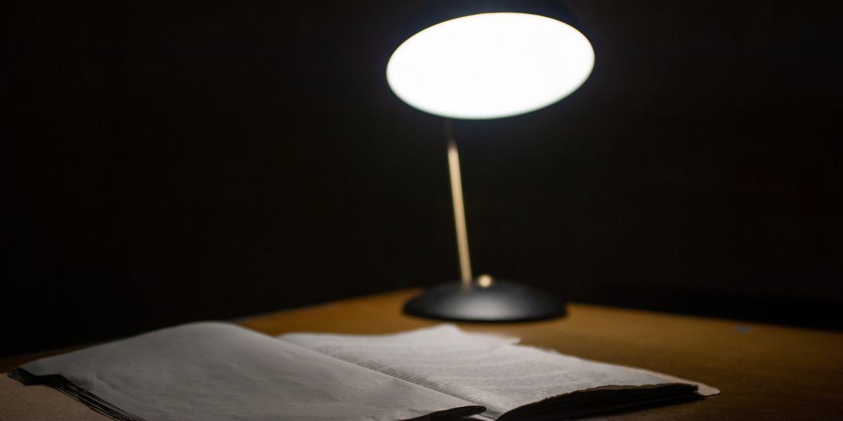 Open book and lamp on a desk