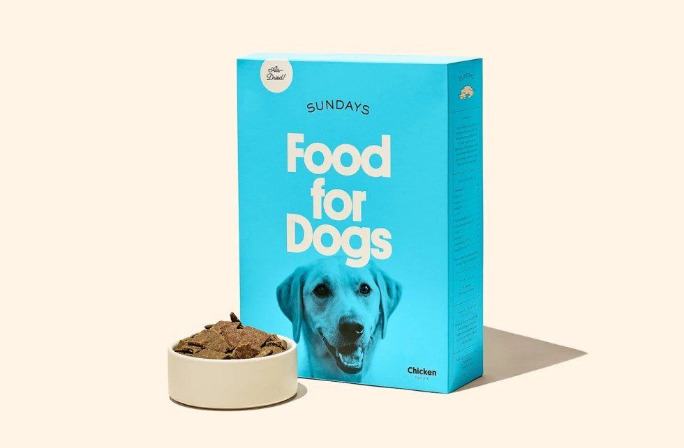 Bright blue dog food box labeled "Sundays" with a white bowl of kibble.