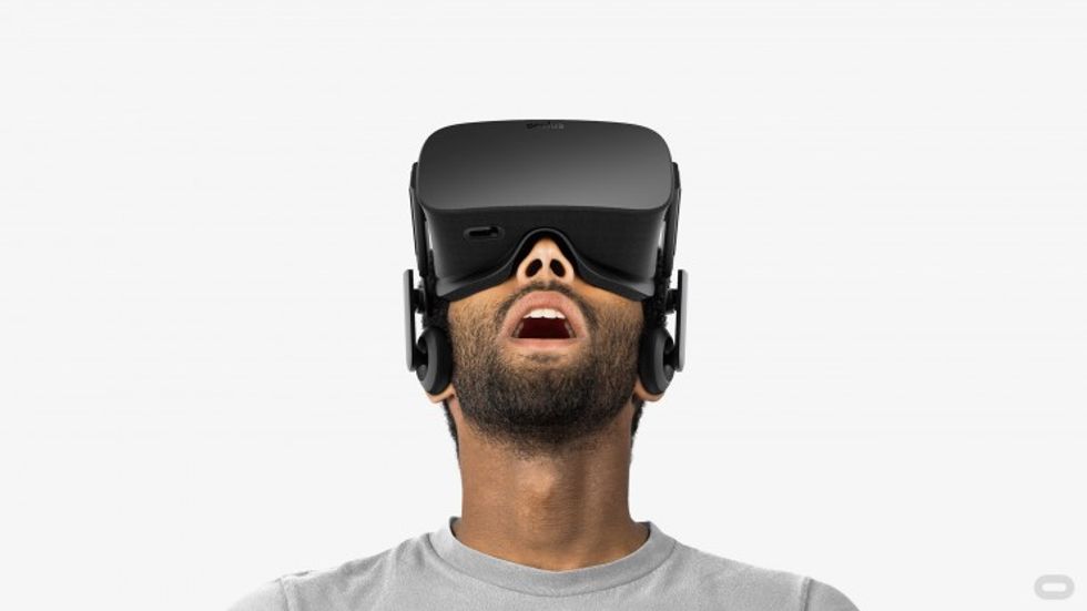a man wearing VR headset looking up in the air photo
