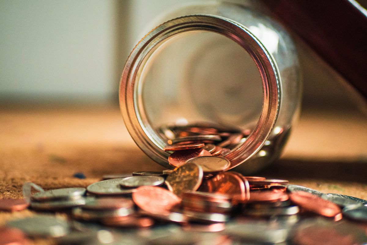 a jar of coins spilled onto the floor