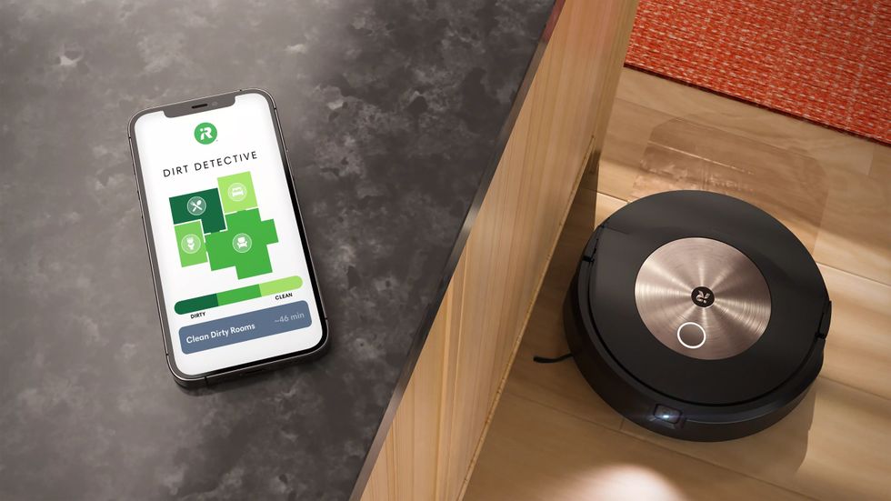iRobot Roomba j9+ robot vacuum and mop and a smartphone showing Dirt Detective