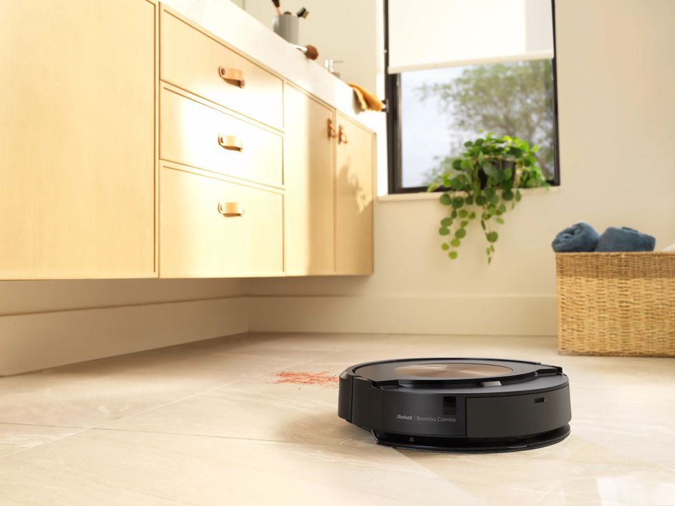 photo of  iRobot Roomba j9+ robot vacuum and mop cleaning bathroom floor