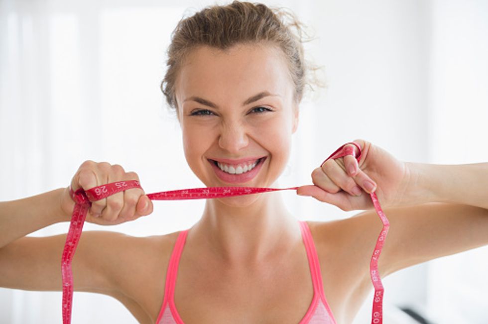 Woman with tap measure for her waist 