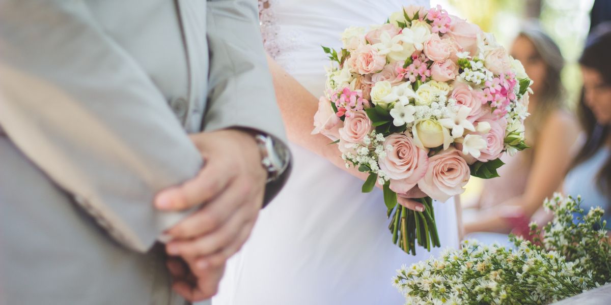 Closeup of bride and groom's hands