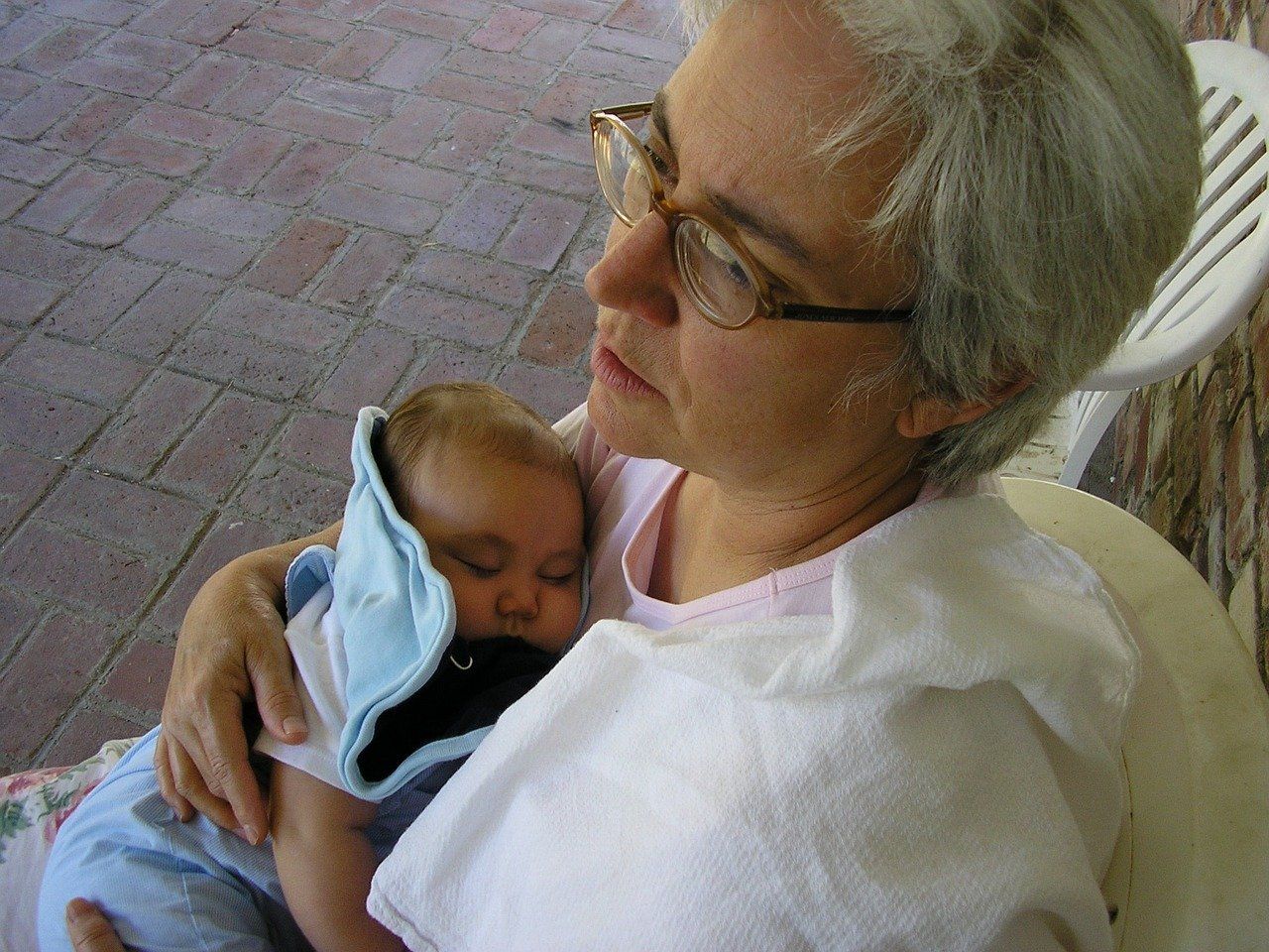 A middle-aged woman holding a baby.