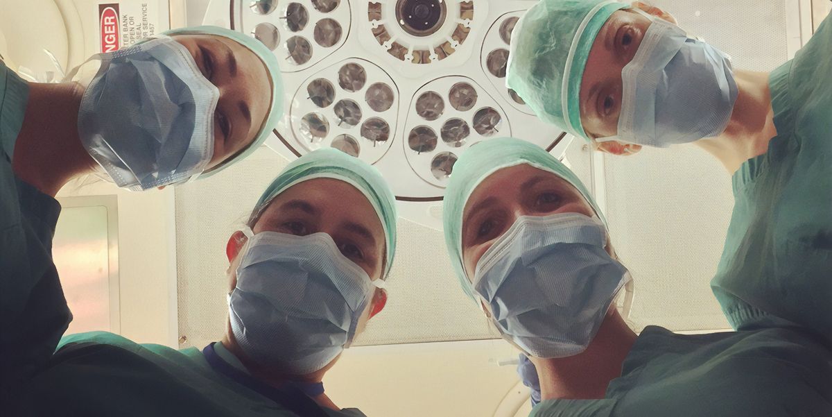 surgeons looking down at patient