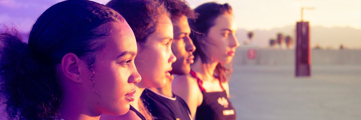 three women and a man looking off in the distance