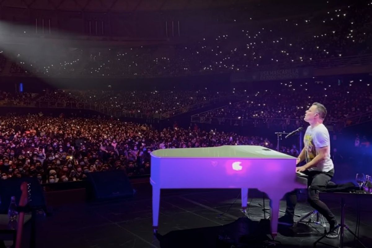 Marc Martel singing in a stadium of people