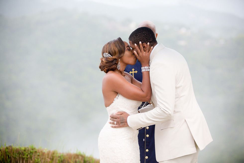 Black-couple-sharing-a-passionate-kiss-as-they-say-I-do-during-their-wedding