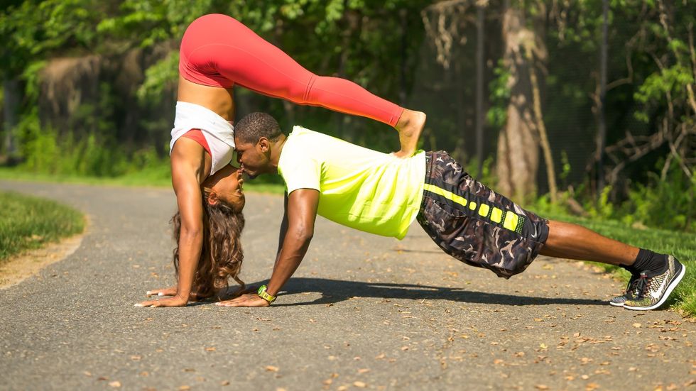black-couple-doing-partnered-yoga-couples-pose-sharing-a-kiss