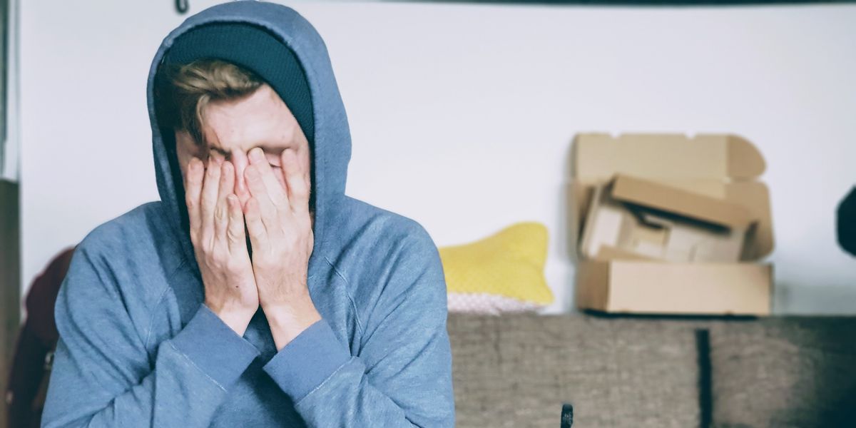 Young man looking defeated with face to palms