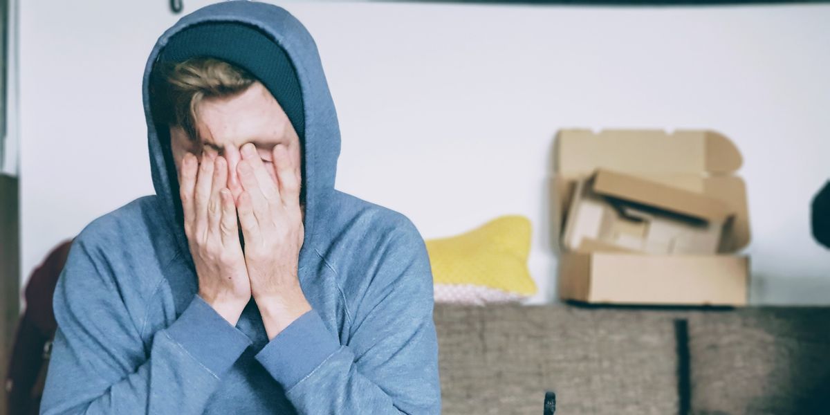 Young man looking defeated with face to palms