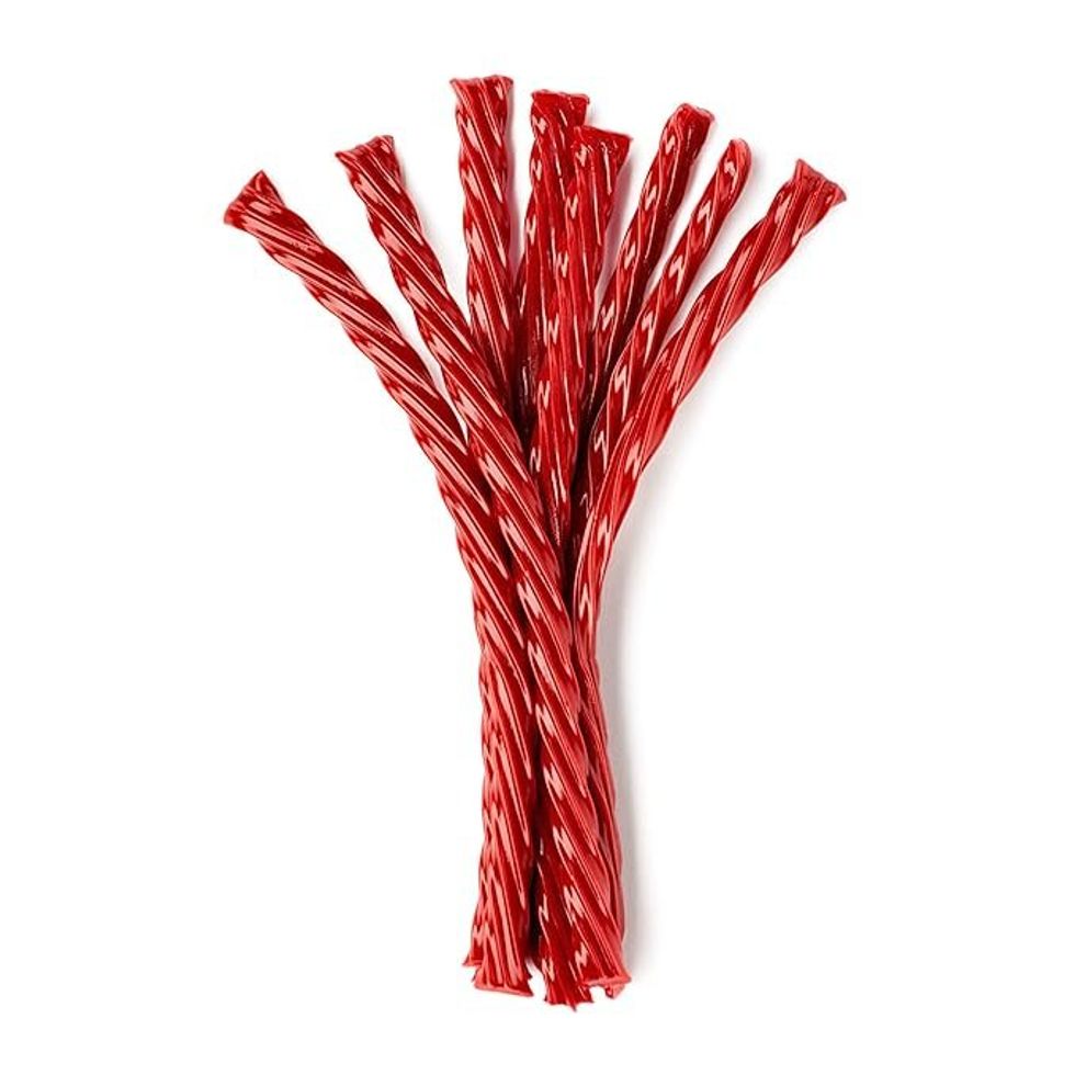 A thread of red, strawberry Twizzlers twisted together.