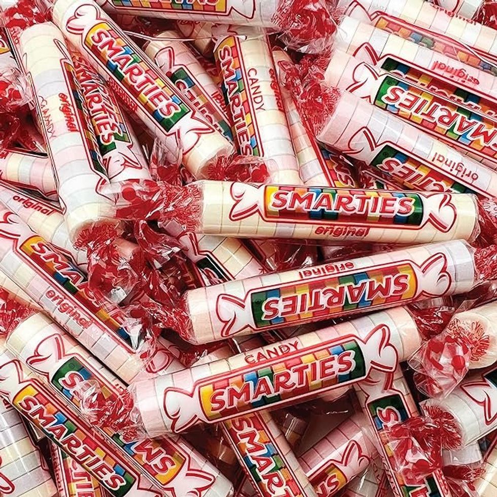 A pile of Smarties candies in wrappers.