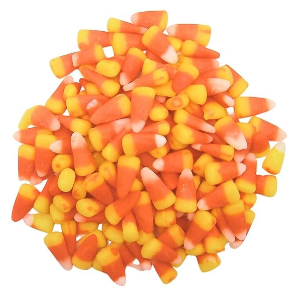 A pile of yellow, orange and white candy corn.