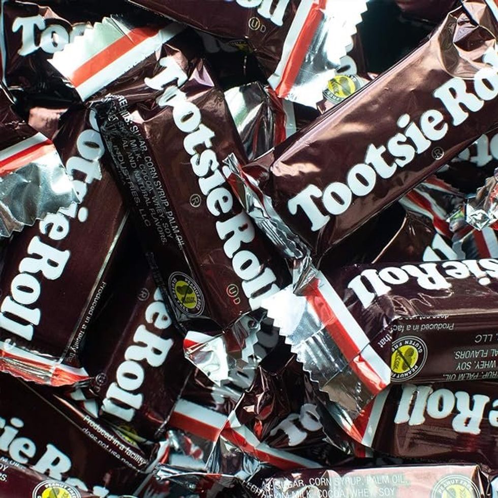 \u200bA pile of large Tootsie Rolls in brown and white wrappers.
