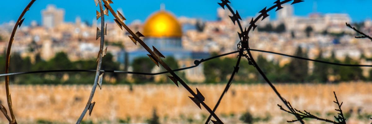 dome of the rock, Jerusalem seen behind barbed wire 