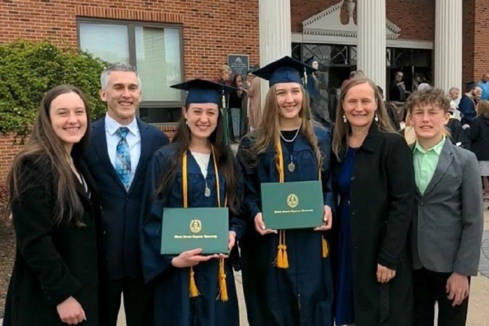 a family of 6 at a graduation with two graduates