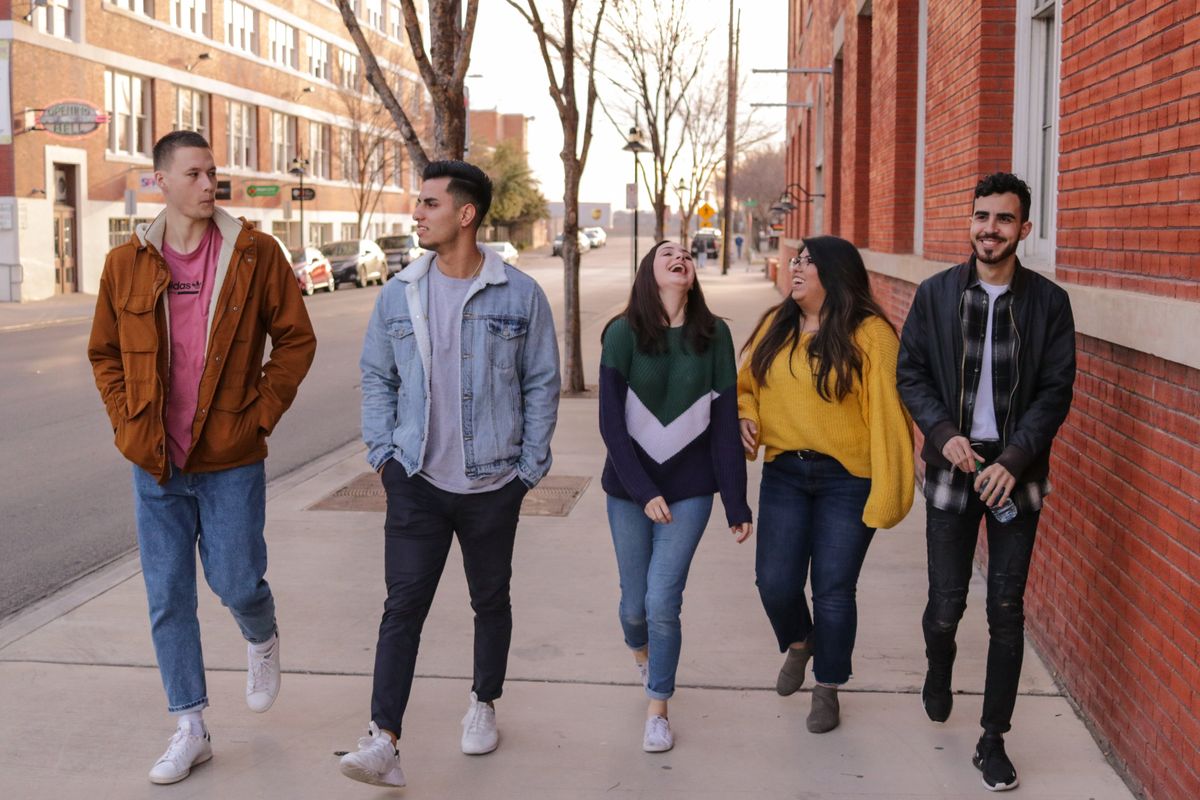 young adults walking down the street 