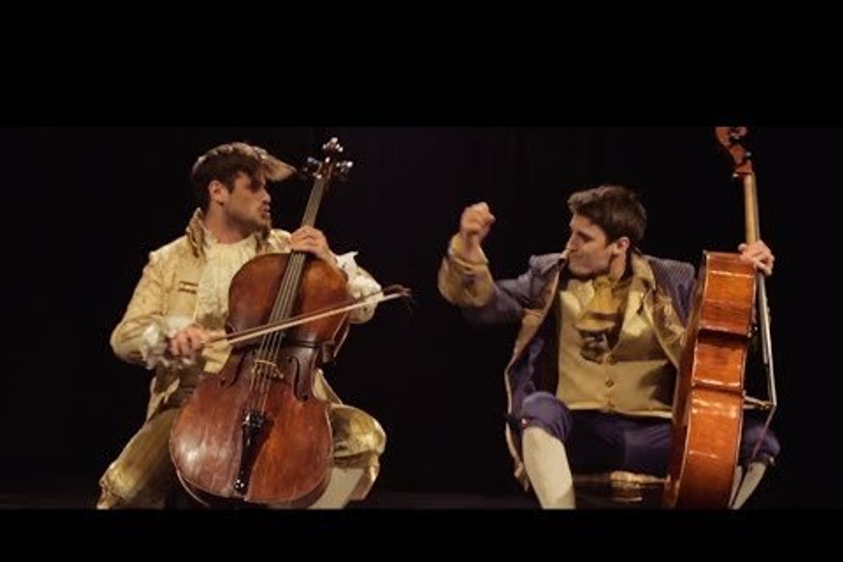 two cellists playing on stage