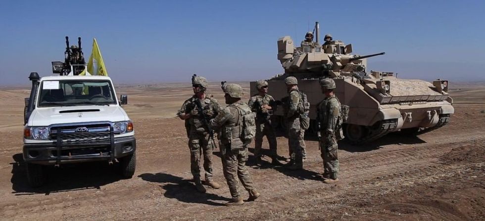 US troops operate a tank in Syria.