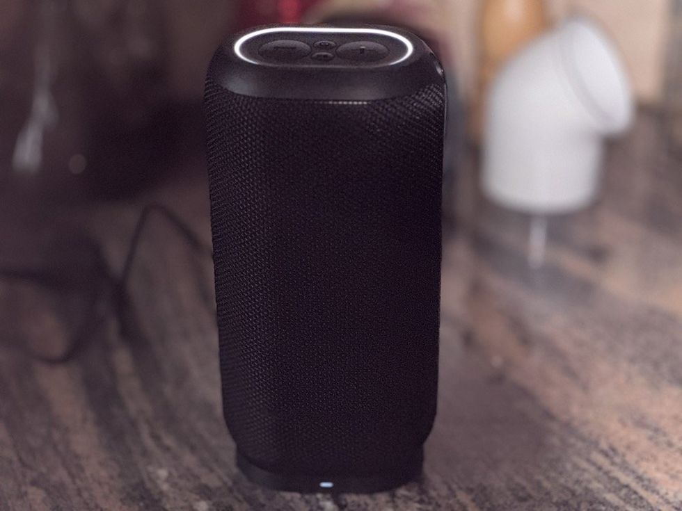 a photo of Monster DNA Max Wireless Speaker on a counter charging.