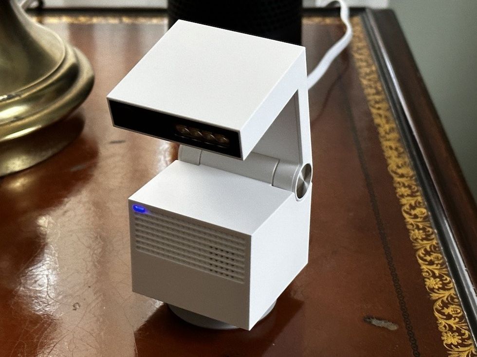 a photo of Genie S camera on a end table plugged in