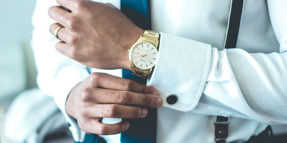 Well dressed man wearing a gold watch