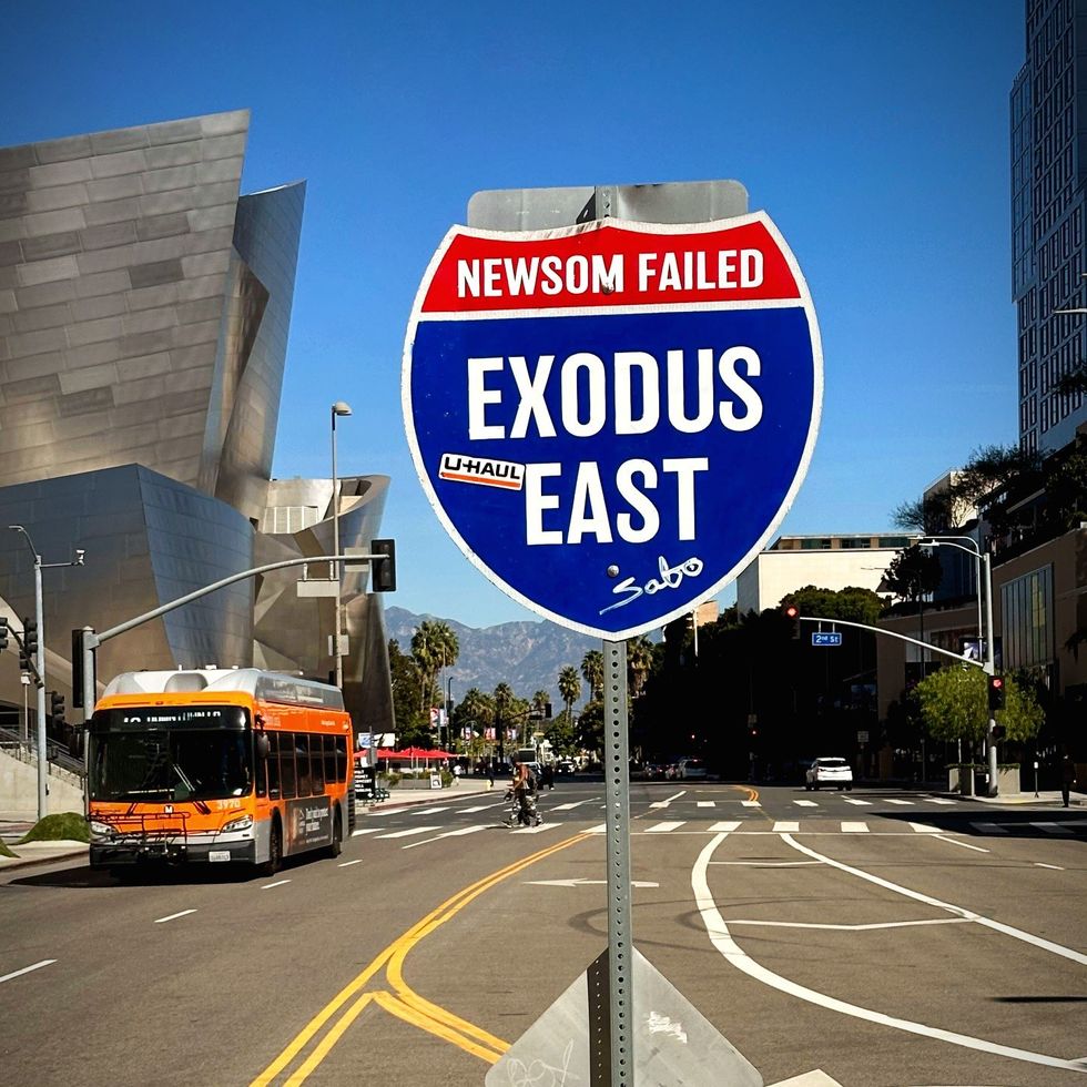 Sabo's "Exodus East" road sign art piece is on display in Downtown LA