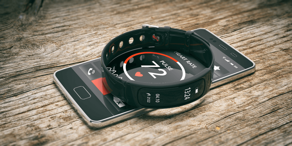 a fitness tracker sittiing on top of a smartphone